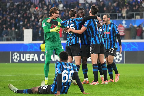 Atalanta players celebrate at the the end of the Champions League opening phase soccer match between Atalanta and Chelsea, in Bergamo, Italy.