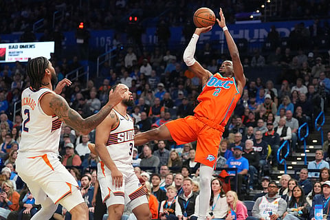Oklahoma City Thunder guard Shai Gilgeous-Alexander (2) shoots over Phoenix Suns center Nick Richards (2) and forward Dillon Brooks (3) during the second half of an NBA Cup basketball game in Oklahoma City.