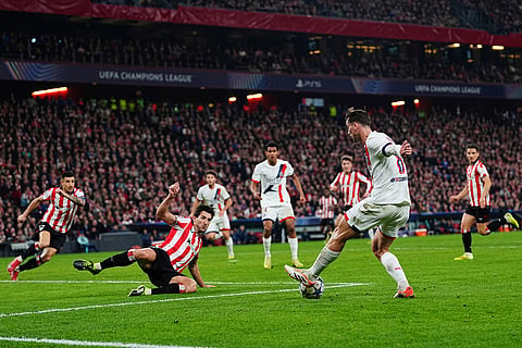 PSG's Fabian Ruiz right, kicks the ball asAthletic Bilbao's Daniel Vivian tries to stop him during the Champions League opening phase soccer match between Athletic Bilbao and PSG in Bilbao, Spain.