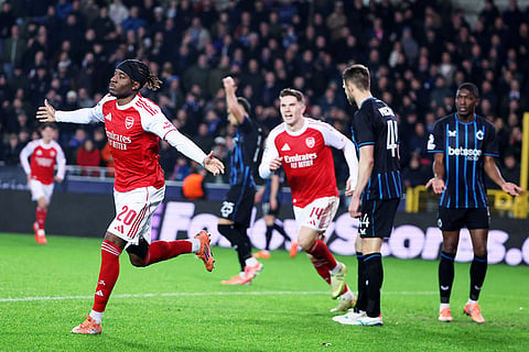 Arsenal's Noni Madueke, left, celebrates after scoring his sides second goal during the Champions League opening phase soccer match between Club Brugge and Arsenal in Bruges, Belgium.