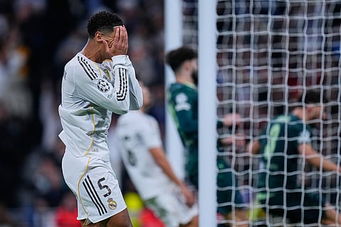 Real Madrid's Jude Bellingham reacts after missing a chance during a Champions League opening phase soccer match between Real Madrid and Manchester City, in Madrid, Spain.