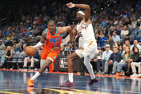 Oklahoma City Thunder guard Jalen Williams, left, drives past Phoenix Suns center Mark Williams, right, during the second half of an NBA Cup basketball game in Oklahoma City. 