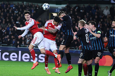Arsenal's Piero Hincapie, second left, goes up against Brugge's Nicolo Tresoldi, center, during the Champions League opening phase soccer match between Club Brugge and Arsenal in Bruges, Belgium.