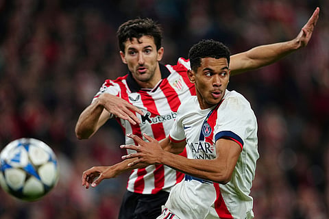 PSG's Senny Mayulu, run for the ball ahead of Athletic Bilbao's Daniel Vivian during the Champions League opening phase soccer match between Athletic Bilbao and PSG in Bilbao, Spain.