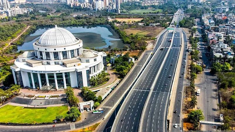 Aerial view of a domed building beside a wide highway