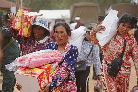 Evacuees receive donation as they take refuge in Oddar Meanchey province, Cambodia after fleeing from home following fighting between Thailand and Cambodia over territorial claims 