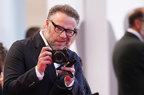 Seth Rogen takes a photograph on the red carpet for the film 'The Smashing Machine' during the 82nd edition of the Venice Film Festival in Venice, Italy, Sept. 1, 2025. 