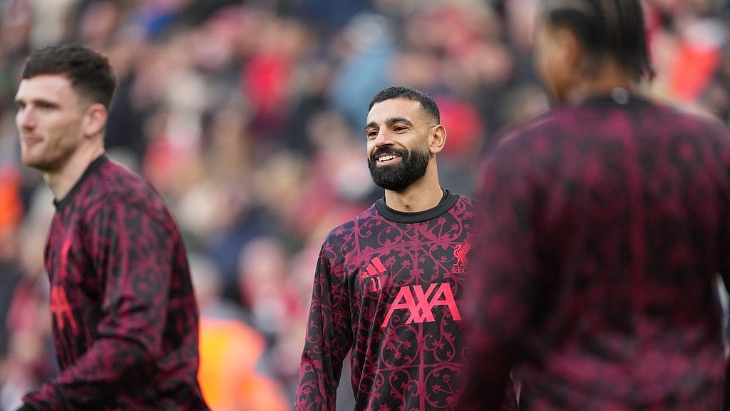 Mohamed Salah, centre, warms up prior to the English Premier League match between Liverpool and Brighton and Hove Albion. - AP