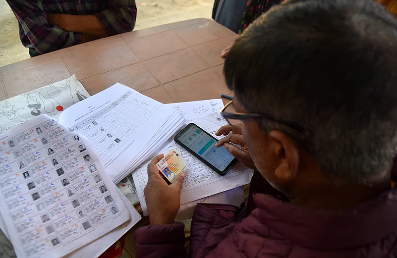 Booth Level Officer (BLO) Re-verifying the voter card during the Special Revision