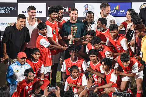 Telangana Chief Minister Revanth Reddy and Argentine footballer and 2022 FIFA World Cup winning captain Lionel Messi presents a trophy to a football team during an event as part of the second leg of 'GOAT India Tour 2025', in Hyderabad.