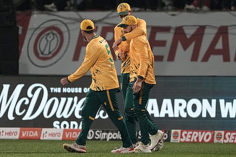 South Africa's players celebrates the dismissal of India's Abhishek Sharma during the third T20 cricket match between India and South Africa in Dharamshala.