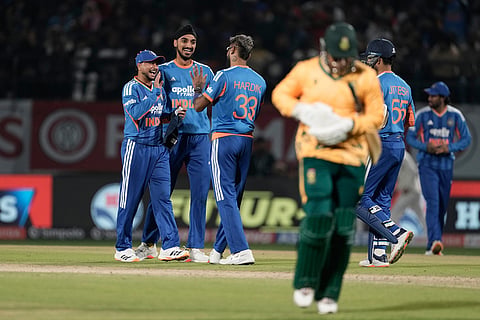 India's Kuldeep Yadav, left, second left, Arshdeep Singh, center, and Hardik Pandya celebrates the wicket of South Africa's Ottneil Baartman during the third T20 cricket match between India and South Africa in Dharamshala.