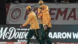 (AP Photo/Ashwini Bhatia) : South Africa's players celebrates the dismissal of India's Abhishek Sharma during the third T20 cricket match between India and South Africa in Dharamshala, India, Sunday, Dec. 14, 2025