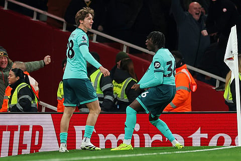 Wolverhampton Wanderers' Fer Lopez, left, and Mateus Mane celebrate after their team scored their first goal during the English Premier League soccer match between Arsenal and Wolves in London.
