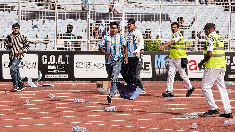 Fans of Argentine footballer Lionel Messi amid chaos during an event as part of his 'G.O.A.T. India Tour 2025', at Vivekananda Yuba Bharati Krirangan (VYBK), in Kolkata. Fans protested after failing to catch a clear glimpse of the footballer despite paying hefty sums for tickets. - Photo: PTI/Swapan Mahapatra