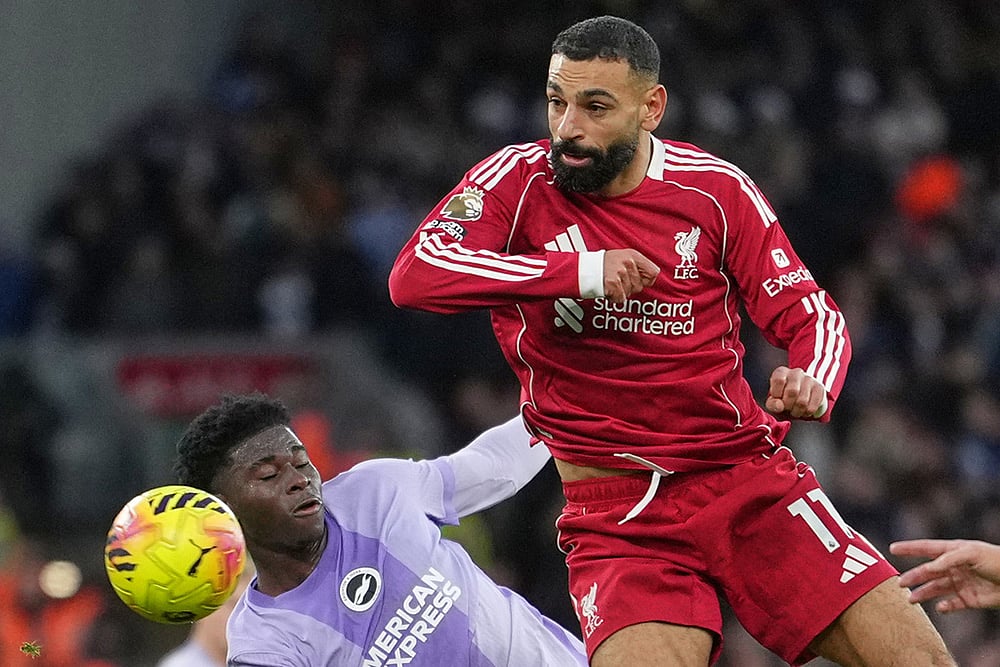 | Photo: AP/Jon Super : Liverpool's Mohamed Salah, right, challenges for the ball with Brighton's Carlos Baleba, left, during the English Premier League soccer match between Liverpool and Brighton and Hove Albion in Liverpool, England.