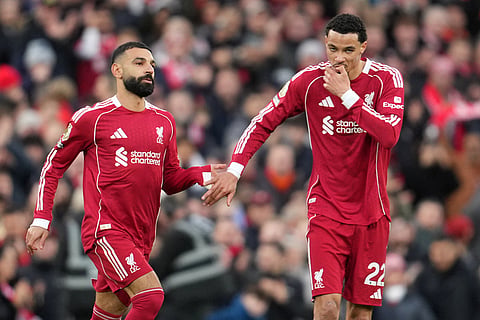 Liverpool's Mohamed Salah, left, and Liverpool's Hugo Ekitike greet each other during the English Premier League soccer match between Liverpool and Brighton and Hove Albion in Liverpool, England.