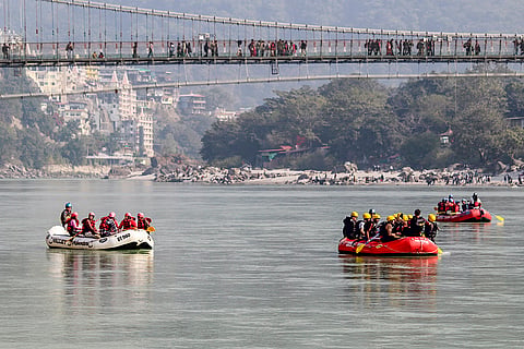 People take part in rafting on the Ganga River, in Rishikesh, Uttarakhand.