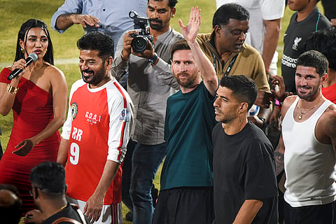 Argentine footballer and 2022 FIFA World Cup winning captain Lionel Messi greets fans during an event as part of the second leg of 'GOAT India Tour 2025', in Hyderabad.