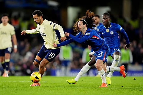 Everton's Iliman Ndiaye, left, and Chelsea's Marc Cucurella battle for the ball during the English Premier League soccer match between Chelsea and Everton in London.