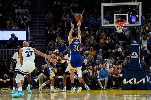 Golden State Warriors guard Stephen Curry (30) shoots a 3-point basket next to Minnesota Timberwolves center Rudy Gobert (27) during the second half of an NBA basketball game in San Francisco. 