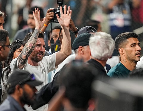 Argentine footballer and 2022 FIFA World Cup winning captain Lionel Messi, left, greets fans during an event as part of the 'GOAT India Tour 2025', at the Wankhede Stadium, in Mumbai.
