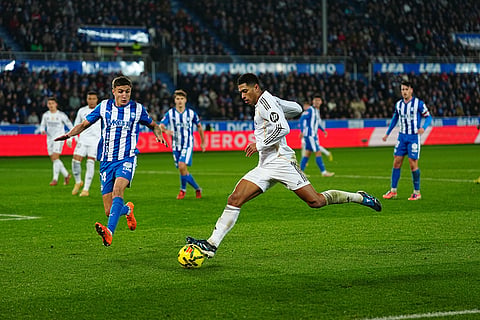 Real Madrid's Jude Bellingham, centre, shoots the ball during the Spanish La Liga soccer match between Alaves and Real Madrid in Vitoria-Gasteiz, Spain.