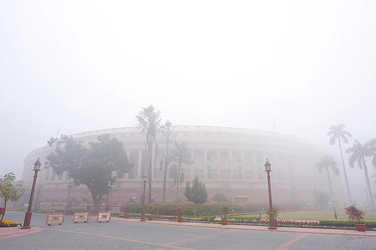 A view of the Parliament House complex on a foggy winter morning, in New Delhi. - | Photo: PTI/Shahbaz Khan