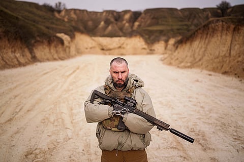 Andrii Rubliuk, a senior sergeant with a Ukrainian intelligence unit who lost both arms and a leg in combat, holds a rifle during military training near Kyiv, Ukraine, Feb. 14, 2025. 