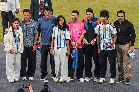 Argentine footballer Lionel Messi and his Inter Miami teammates Rodrigo De Paul and Luis Suarez with fans during the final leg of 'GOAT India Tour 2025', at Arun Jaitley Stadium in New Delhi.