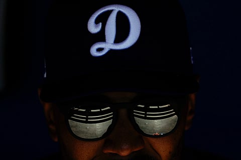 Los Angeles Dodgers shortstop Mookie Betts sits in the dugout during a spring training baseball game against the Chicago Cubs, Feb. 20, 2025, in Phoenix. 