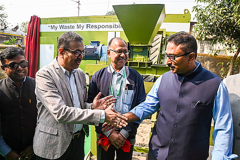 Syama Prasad Mookerjee Port Chairman Rathendra Raman, right, greets Evergreen Future CEO Debashis Bose, second left, during the launch of an Ecogenik waste-to-solid fuel machine, near Armenian Ghat, in Kolkata.