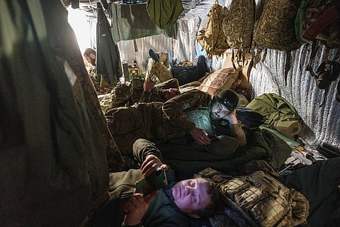 Ukrainian servicemen of the 148th artillery brigade rest in a trench after firing towards Russian positions at the frontline's Velyka Novosilka direction, Donetsk region, Ukraine, Jan. 26, 2025. 