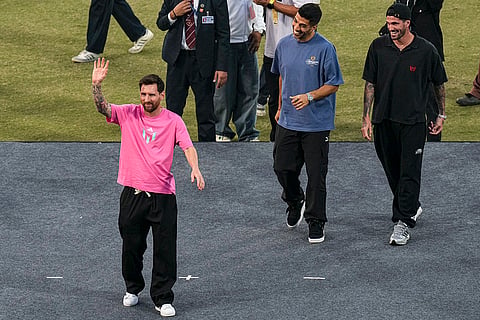 Argentine footballer Lionel Messi greets the gathering during the 'GOAT India Tour 2025', at Arun Jaitley Stadium in New Delhi.