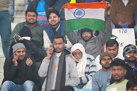Fans wave the national flag ahead of the fourth T20 International cricket match of a series between India and South Africa, at Ekana Cricket Stadium in Lucknow.