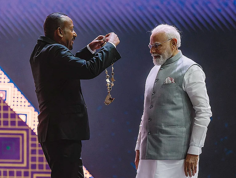 Prime Minister Narendra Modi being conferred with Ethiopia's highest award 'The Great Honour Nishan of Ethiopia' by his Ethiopian counterpart Abiy Ahmed Ali during a ceremony at the Addis International Convention Centre, in Addis Ababa. - | Photo: @PMEthiopia/X via PTI