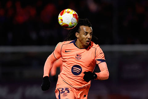 Barcelona's Jules Kounde runs with the ball during the Copa del Rey soccer match between Guadalajara and Barcelona in Guadalajara, Spain.