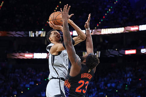 San Antonio Spurs forward Victor Wembanyama (1) shoots against New York Knicks center Mitchell Robinson (23) during the first half of the NBA Cup championship basketball game in Las Vegas.
