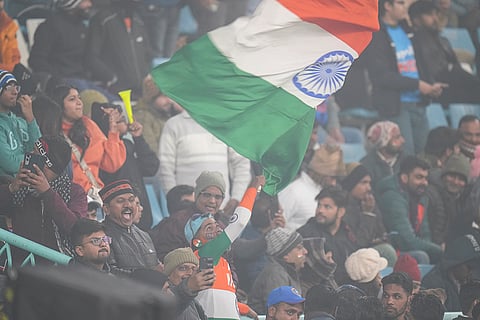 Fans wave the national flag ahead of the fourth T20 International cricket match of a series between India and South Africa, at Ekana Cricket Stadium in Lucknow. The match was called off due to poor visibility caused by dense layer of smog. 