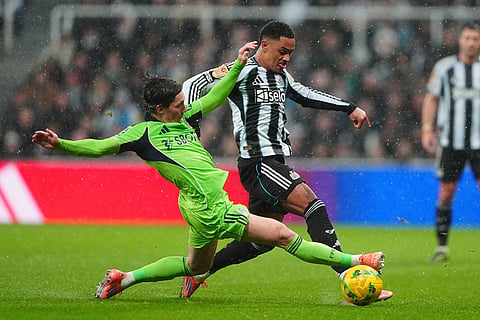 Fulham's Harry Wilson, left, and Newcastle United's Jacob Ramsey battle for the ball during the English League Cup quarter final soccer match between Newcastle and Fulham in Newcastle upon Tyne, England.