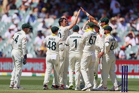 Australia's captain Pat Cummins, third from left, celebrates the wicket of England's Jamie Smith with his teammates during play on day two of the third Ashes cricket test between England and Australia in Adelaide, Australia.