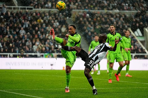 Fulham's Kenny Tete, left, and Newcastle United's Yoane Wissa battle for the ball during the English League Cup quarter final soccer match between Newcastle and Fulham in Newcastle upon Tyne, England.