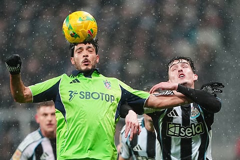 Fulham's Raul Jimenez, left, and Newcastle United's Tino Livramento battle for the ball during the English League Cup quarter final soccer match between Newcastle and Fulham in Newcastle upon Tyne, England.