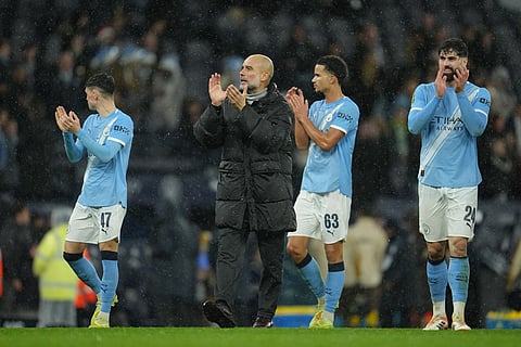 Manchester City's head coach Pep Guardiola and players applaud fans after the English League Cup soccer match between Manchester City and Brentford in Manchester, England.