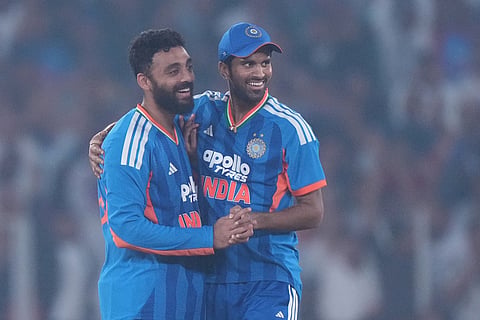India's Varun Chakaravarthy, left, celebrates with teammate Washington Sundar the wicket of South Africa's Reeza Hendricks during the fifth T20 cricket match between India and South Africa in Ahmedabad.