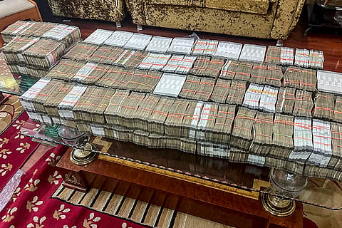 Cash seized by the Enforcement Directorate (ED) officials from the premises of a Delhi-based travel agent during a raid in a money laundering investigation linked to illegal transportation of Indians to the US through the 'dunki' route. 