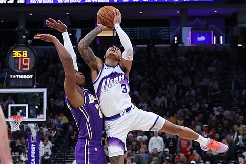Utah Jazz guard Keyonte George (3) is fouled by Los Angeles Lakers forward Rui Hachimura (28) during the second half of an NBA basketball game in Salt Lake City. 