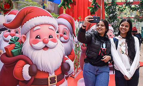 Women pose for a picture during the Christmas Carnival ahead of the festival, in Ranchi.