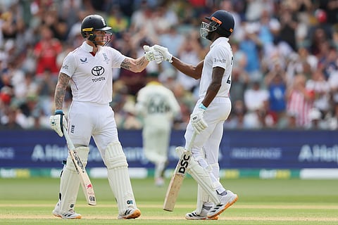 England batsmen Jofra Archer, right, and Ben Stokes react during play on day three of the third Ashes cricket test between England and Australia in Adelaide, Australia.