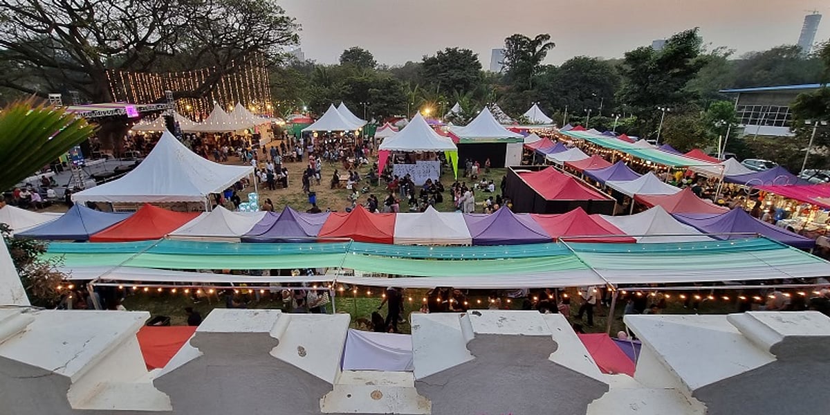Aerial view of the Sunday Soul Sante Christmas market with colorful tents and festive crowds.
